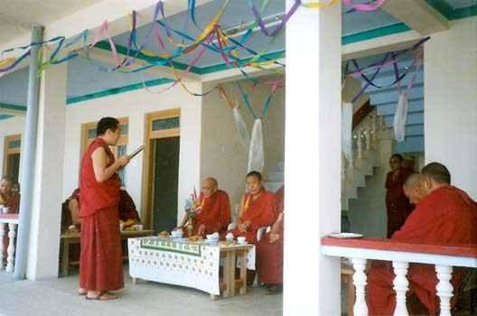 Drepung Director reading acknowledgments to the donors